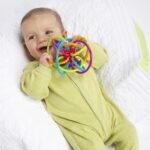 Manhattan Toy Winkel Rattle & Sensory Teether Toy in Blue, Green, and Orange - 5x4x3.5 Inch